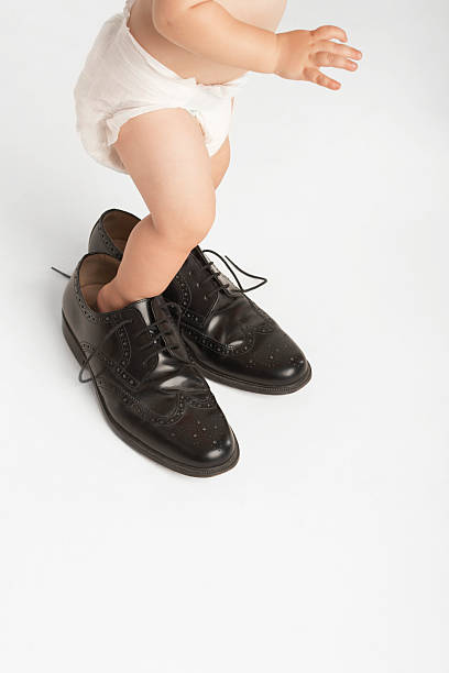 istock Baby Wearing Man's Shoes 462785791