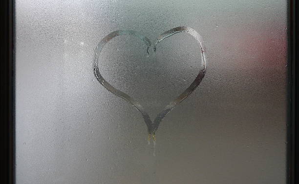 istock heart on foggy window 462795107
