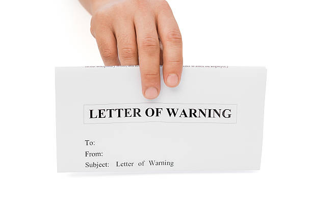 istock man's hand holding a letter of warning with clipping path 462803525