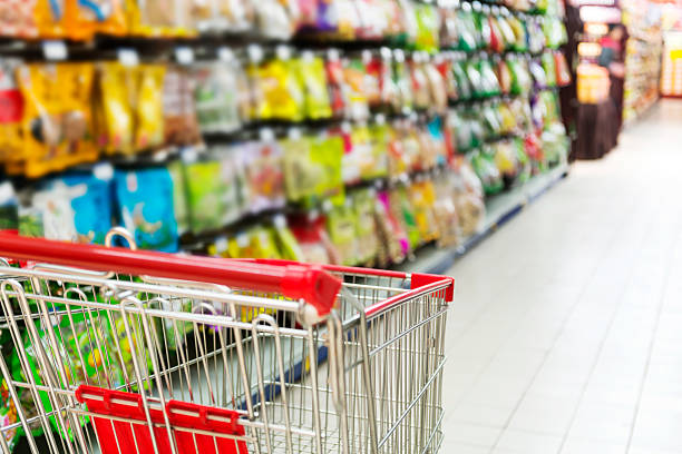 istock Supermarket interior, empty red shopping cart. 462804769
