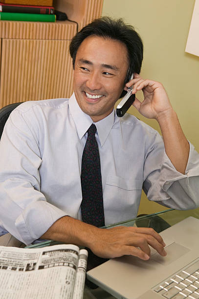 istock Businessman Using Laptop and Reading Newspaper 462806149
