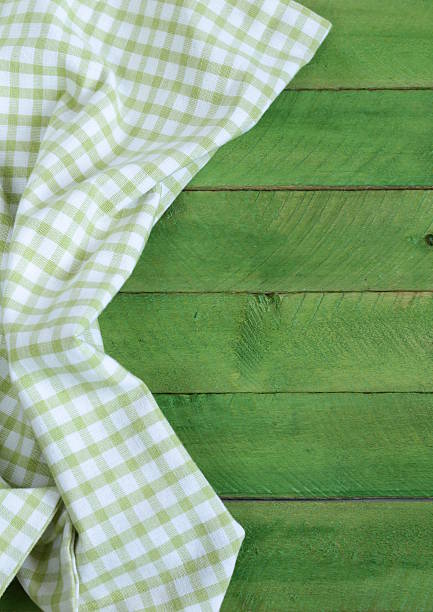 istock Wooden background with green checkered kitchen towel 462809273