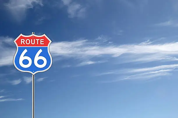 Red and blue Route 66 Road Sign isolated on blue sky background.