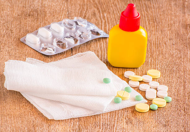 istock Medical pill on wooden table. 462813467