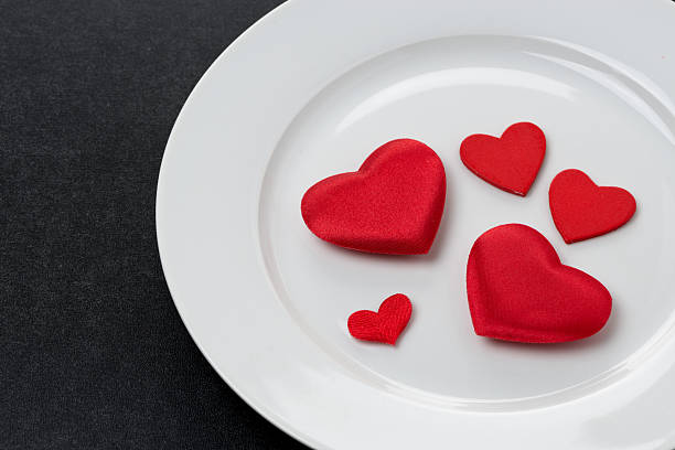 istock red hearts on a white plate, festive serving element, close-up 462814341