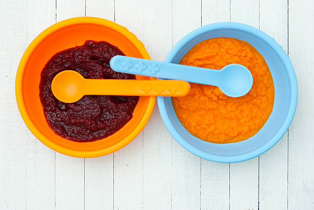 Baby foods baby foods from pumpkin and beet baby spoon stock pictures, royalty-free photos & images