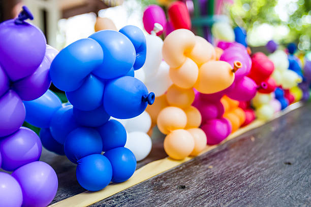 Balloon animal many stand in a line on the table.
