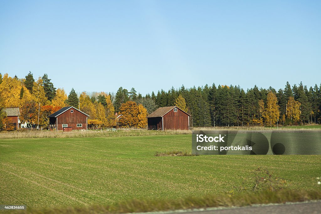 Swedish countryside scenery Old red wooden house in Sweden in countryside landscape Agriculture Stock Photo