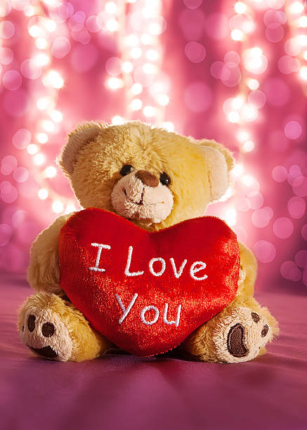 Little teddy bear with big red heart stock photo