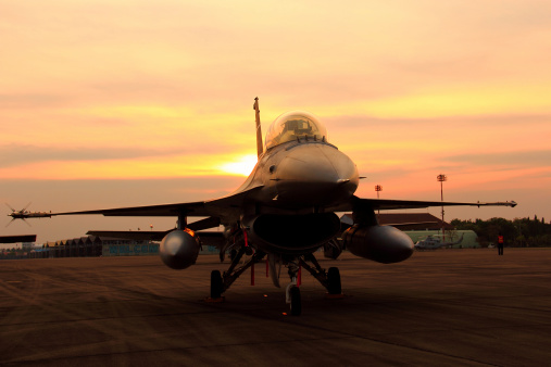 F16 Falcon fighter jet on sunset  background
