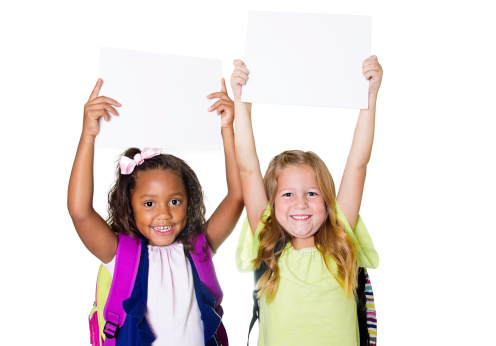 Two cute diverse girls raising up a blank white sign. Room for a message