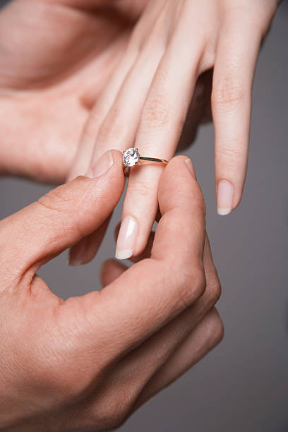 istock Man Placing Engagement Ring In Woman's Finger 462857767