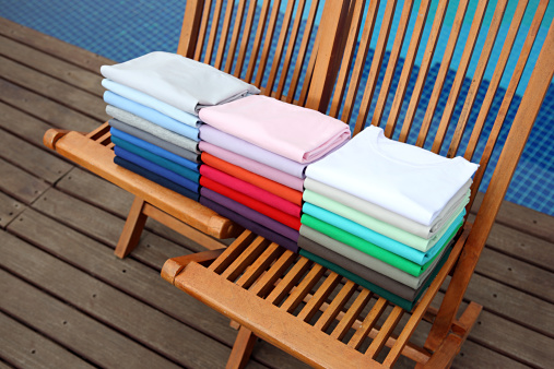 Coloured T-shirts in a row.