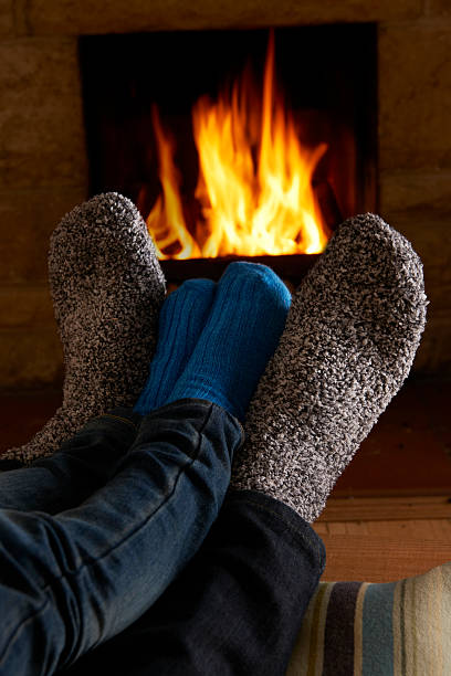 istock Father And Child Warming Feet By Fire 462866565