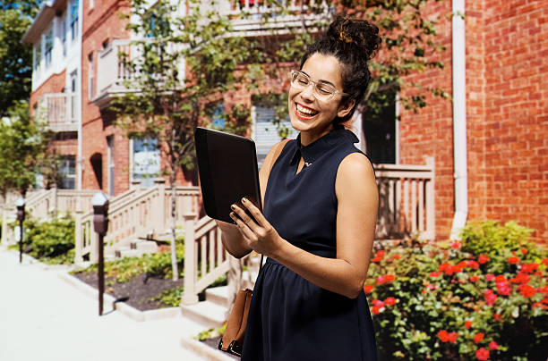 istock Smiling businesswoman using tablet on street 462867227