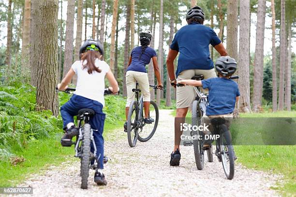 Family Of Four Riding Bicycle Stock Photo - Download Image Now - Autumn, Child, Family