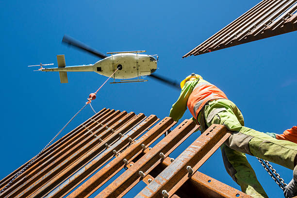 helicopter transporting steel wall to mechanic
