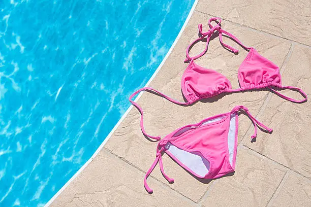 Picture of a pink bikini at the edge of a pool.  http://www.thephoto.ca/temp/ist/lightbox/TropicalDestinations1.jpg