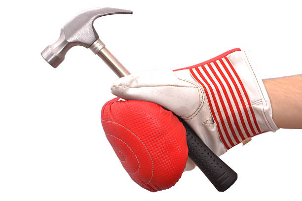 Boxing glove holding a hammer stock photo