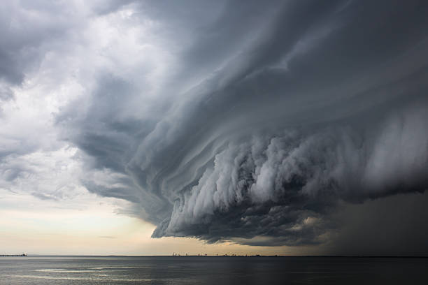 Epic super cell storm cloud A mean looking huge storm cloud hovering over the ocean. ominous photos stock pictures, royalty-free photos & images