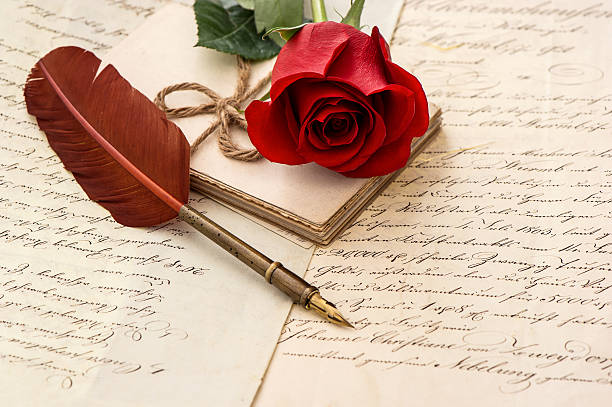 old letters, rose flower and antique feather pen. romantic vintage background. selective focus