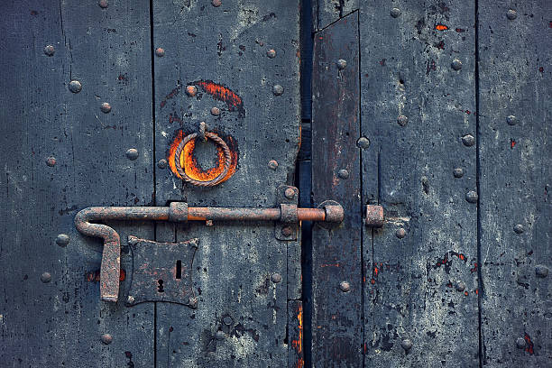 istock Rusty bolt on old wooden door. 462884935