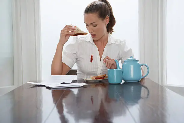 Photo of Woman dropping jam down her blouse at breakfast