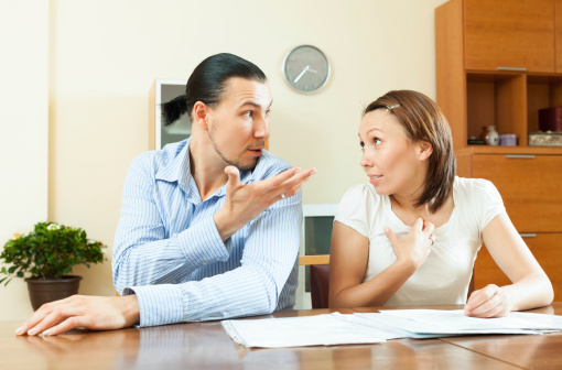 Adult couple having conflict about family budget at home