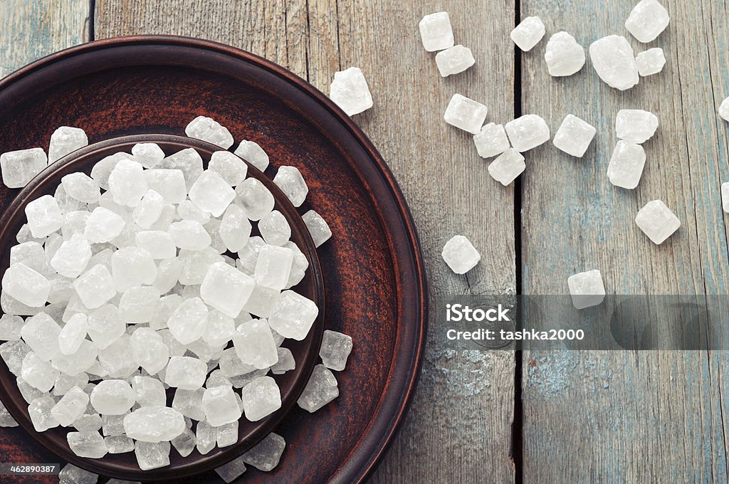 White candy sugar White candy sugar on brown plate. Top view. Baking Stock Photo