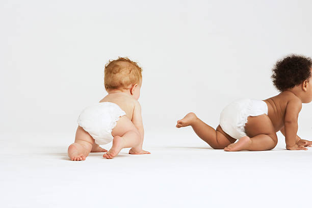 Baby Boys Crawling Baby boys crawling isolated on white background crawling photos stock pictures, royalty-free photos & images