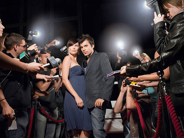 istock Couple Posing In Front Of Paparazzi 462903483