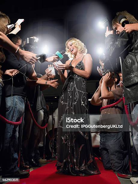 Woman Signing Autographs On Red Carpet Stock Photo - Download Image Now - Red Carpet Event, Fame, Microphone