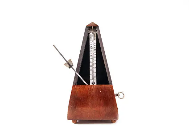 Vintage wooden metronome music timer on the white background