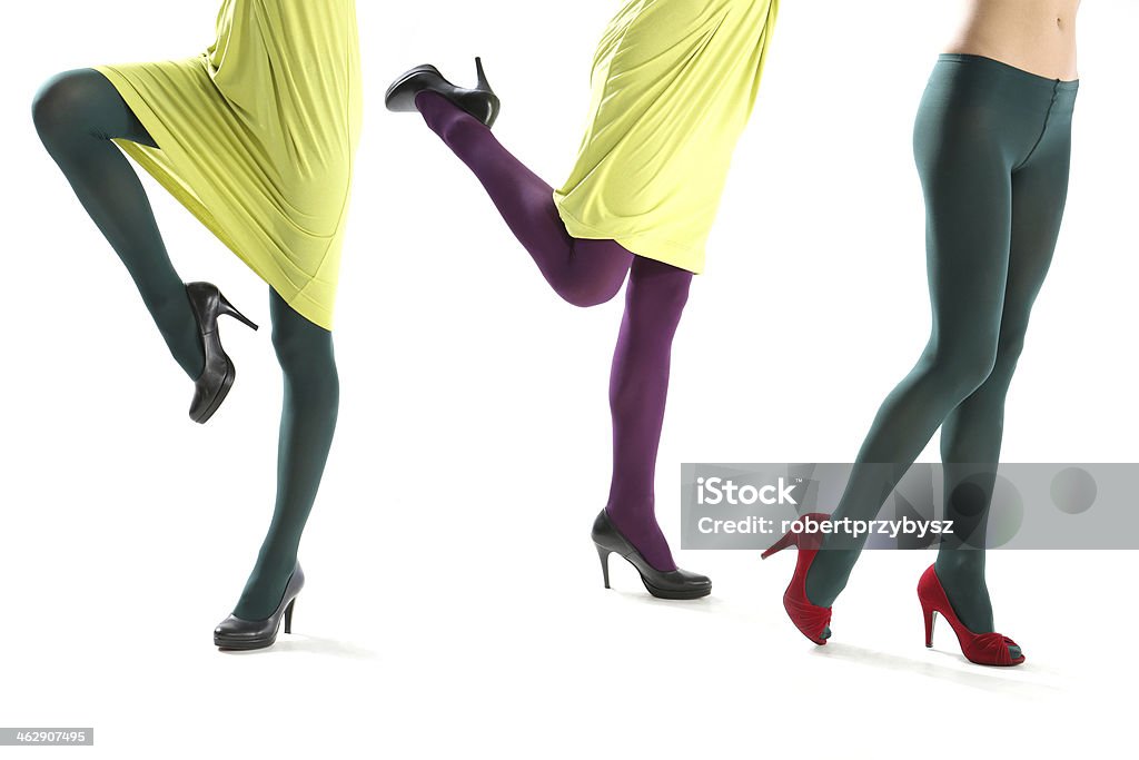 Funny female leg Shapely female legs clad in colorful tights isolated on white background Pantyhose Stock Photo