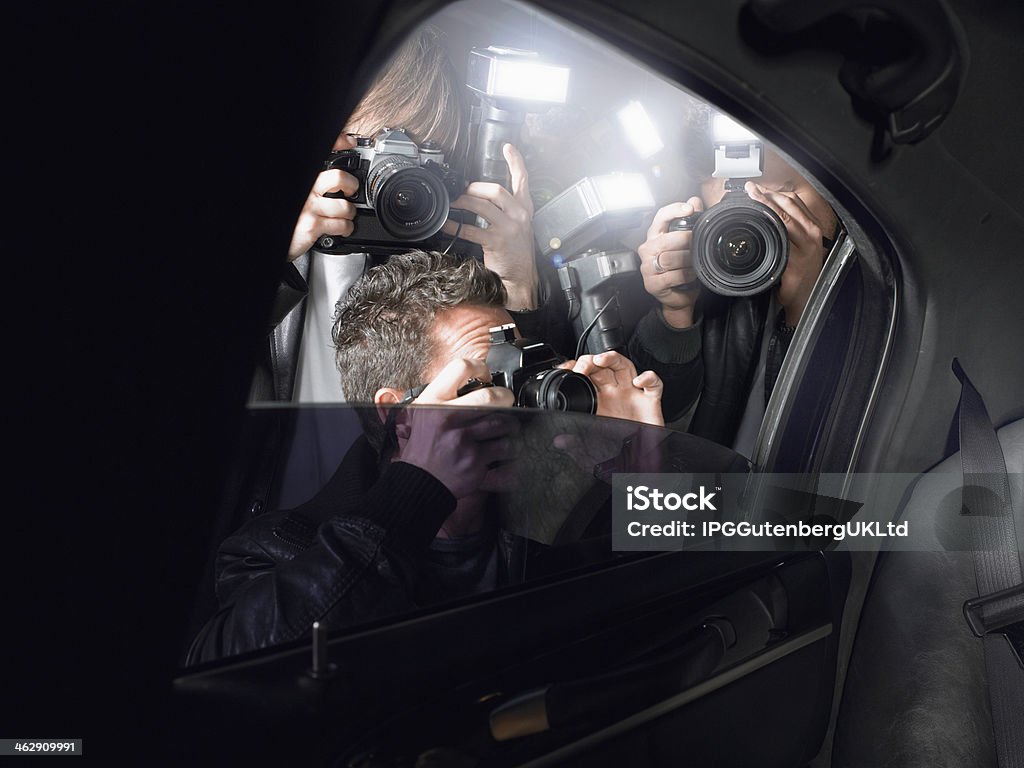 Paparazzi Shooting Through Car Window Paparazzi taking pictures through car window Paparazzi Photographer Stock Photo