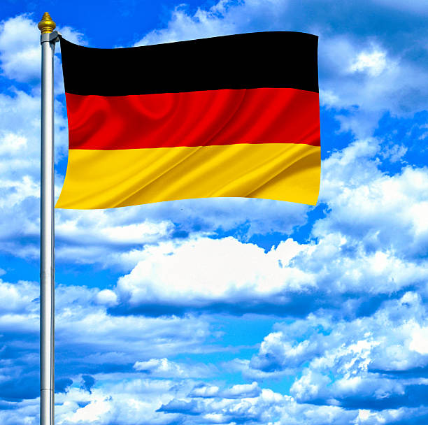 istock Germany waving flag against blue sky 462915189
