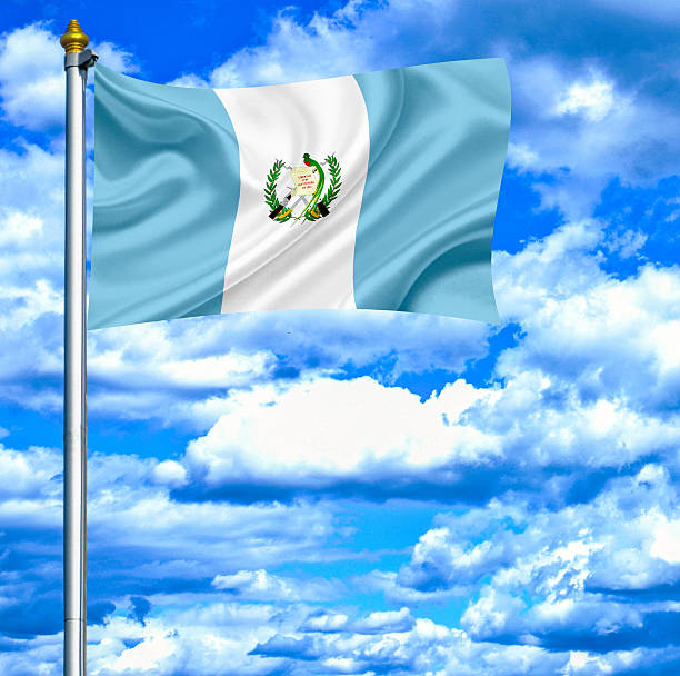 istock Guatemala waving flag against blue sky 462915963