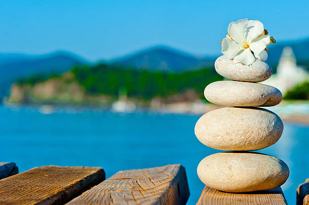 istock construction of smooth stones on a wooden pier 462918159