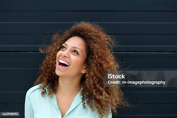 Beautiful Young Woman Laughing Outdoors And Looking Up Stock Photo - Download Image Now