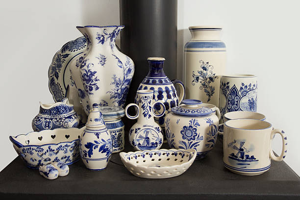 Vases and tableware in blue and white. Collected at garage sales and markets. Most hand painted and Dutch. Placed on a wood stove.