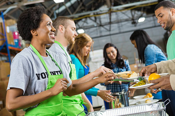 istock Volunteers serving healthy hot meal at soup kitchen 462940167