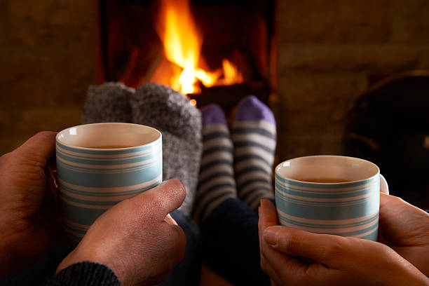 istock Couple With Hot Drink Relaxing By Fire 462944515