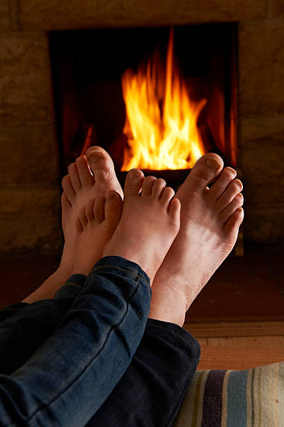 istock Father And Child Warming Feet By Fire 462944681