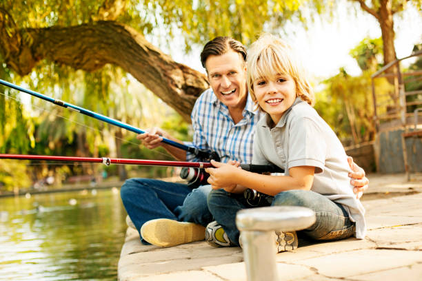 istock Father and son fishing on dock 462946053