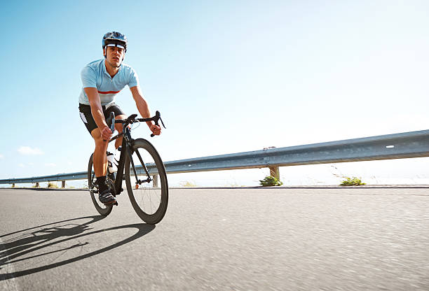 istock Man riding a bicycle on scenic road 462947545