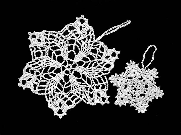 Crocheted Snowflakes Two white crocheted snowflakes, star form, used as decoration for a Christmas tree lacemaking photos stock pictures, royalty-free photos & images