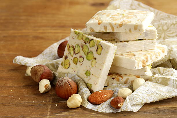 istock white nougat with different nuts on a wooden table 462959609