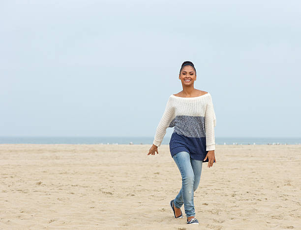 istock Cheerful young woman walking on a beach 462961141