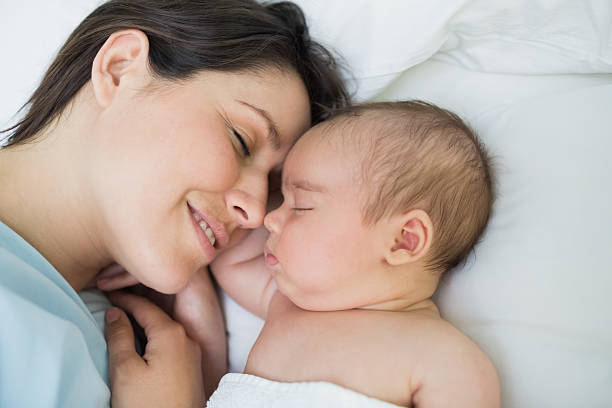 istock Smiling mother and baby sleeping 462967743