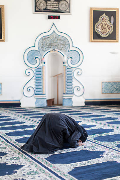 istock Muslim woman praying in mosque 462968195